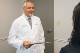 Picture of a Doctor standing in a room at GI Specialists of Georgia