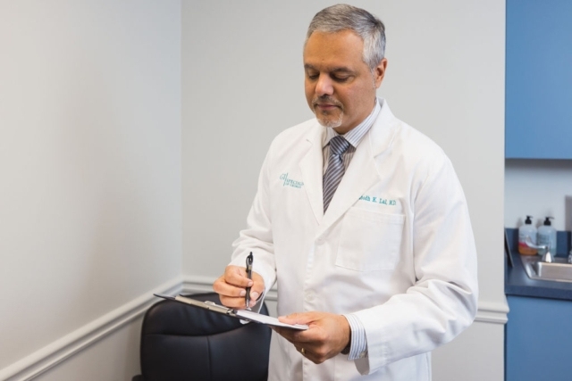 Doctor reviewing notes on a clipboard during a patient consultation in a clinic in Atlanta, GA