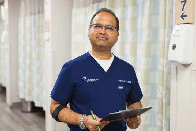 GI Specialists team member candid photo checking patient's docs
