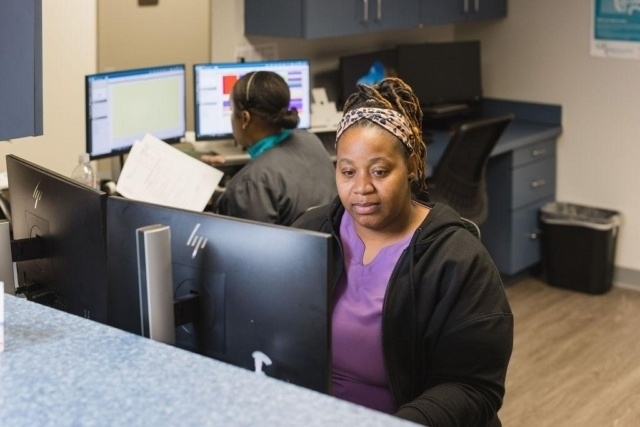 Medical office staff working at computer stations in a clinic in Atlanta, GA