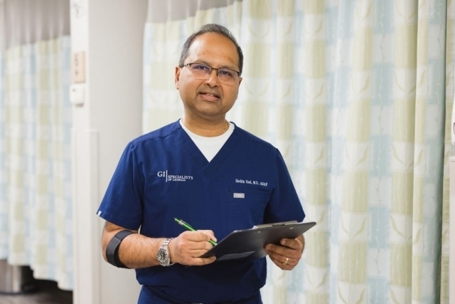 Medical professional reviewing patient notes on a clipboard in a clinic in Atlanta, GA