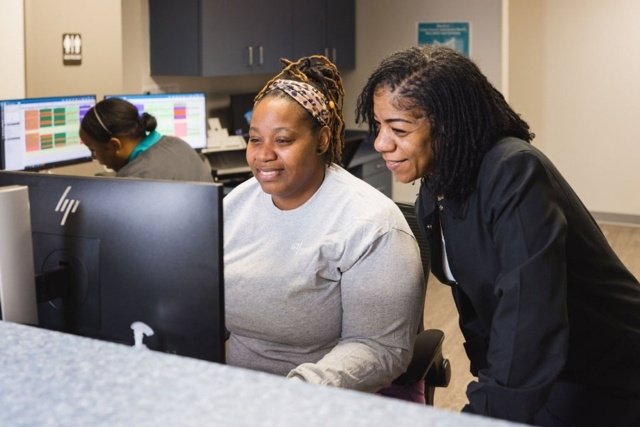 office-collaboration Two people working at a computer at GI Specialists of Georgia in Atlanta, GA