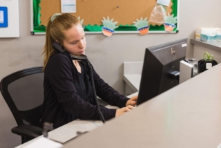 Receptionist on a call at GI Specialists of Georgia