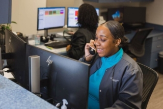 A woman on a call while looking at a screen at GI Specialists of Georgia