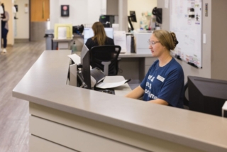 Women collaborating at the reception desk at GI Specialists of Georgia