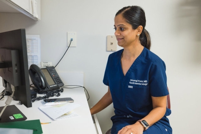 medical-professional-at-desk Dr. Umangi Patel is Working on a Patient's GI Report at the GI Specialists of Georgia's Office