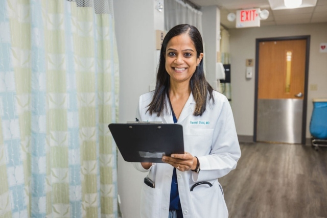medical-professional-with-clipboard Dr. Umangi Patel of GI Specialists of Georgia Is Holding a Clipboard in a Hospital Hallway