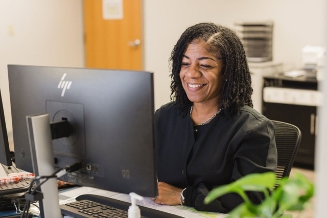 women-worker-using-computer A Person Working at a Desk on a Computer in the GI Specialists of Georgia's Office