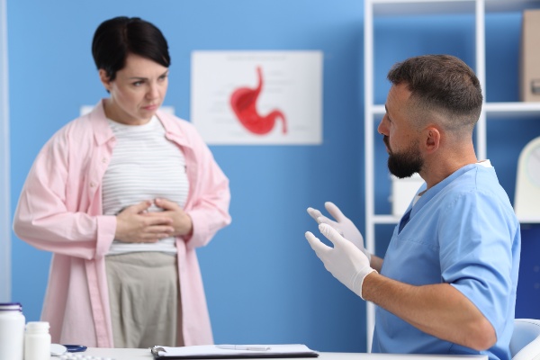 Gastroenterologist consulting patient with stomach pain